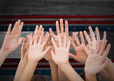 Hands up against american flag in background