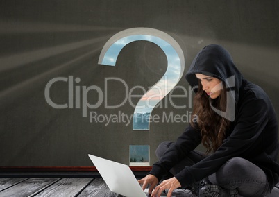 Woman hacker using a laptop in a room with question mark on it