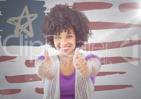 Woman giving two thumbs up against hand drawn american flag and white wall with flare