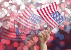 Hands holding american flags against shiny background