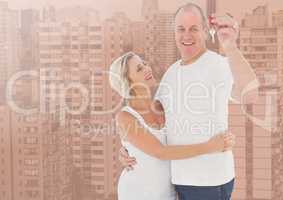 Couple Holding Keys with city