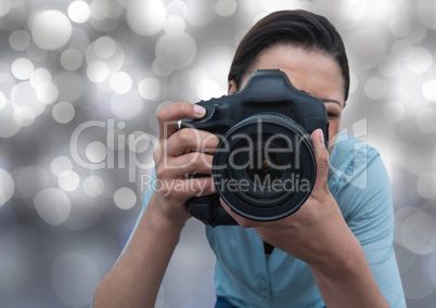 3d photographer taking a photo (foreground) with silver bokeh background