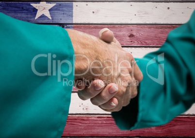 Senior people shaking their hands against american flag