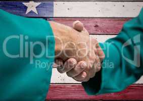 Senior people shaking their hands against american flag