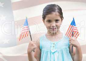ILittle girl holding Americans flags against american flag