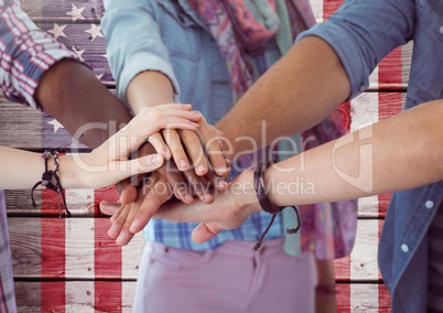 Smiling Friends with hands together against american flag