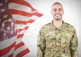 Smiling soldier near fluttering american flag