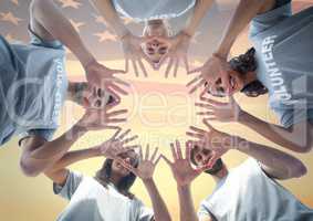 Friends with hands together against american flag