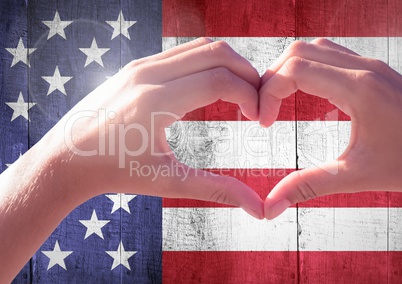 Hands showing a heart against american flag