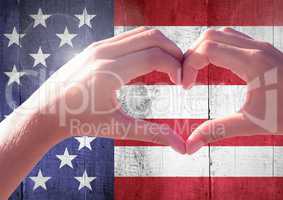 Hands showing a heart against american flag