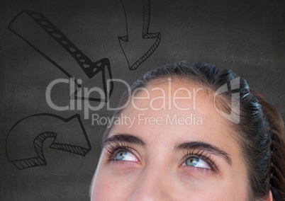 Top of womans head looking at downward 3D arrows against grey wall