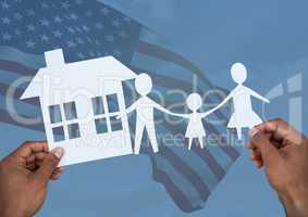 hands holding a family and a house on paper against american flag