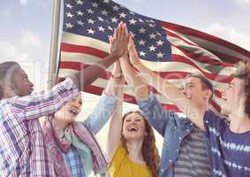 Friends high fiving together against 3D american flag