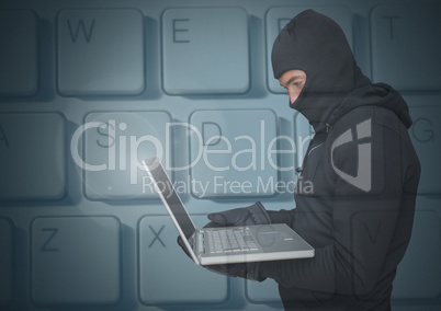 Hacker using a laptop in front of digital background of keyboard