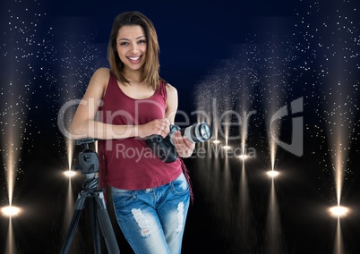 young photographer with camera on hands and rest on the tripod in lights corridor