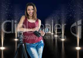 young photographer with camera on hands and rest on the tripod in lights corridor