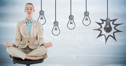 Business woman meditating against blurry blue wood panel and 3D grey lightbulb graphic