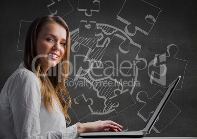 Woman at laptop against grey wall with 3D white jigsaw doodle