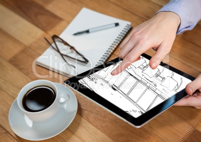 tablet with hands on a desk with the design of the new office (white and black)