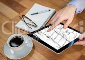 tablet with hands on a desk with the design of the new office (white and black)