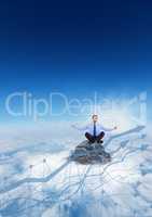 Business man meditating on mountain peak behind 3d blue graph