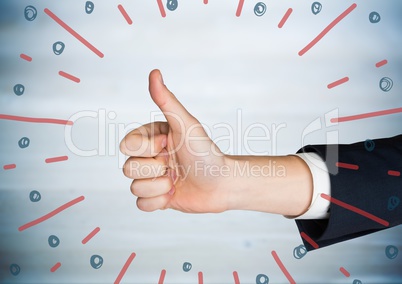 Hand giving thumbs up against blurry blue wood panel and red blue fireworks doodle