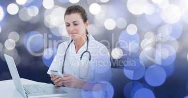 Woman doctor texting with spotlights in background