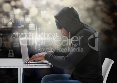 Hacker using a laptop in front of digital background