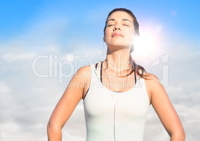 Woman soaking up sun against sunny sky with flare
