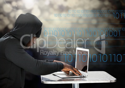 Hacker using a laptop in front of digital background