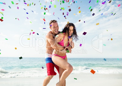 Confetti and couple at beach