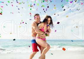 Confetti and couple at beach