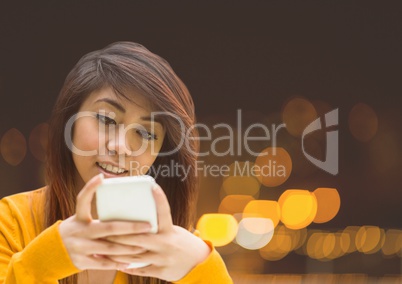 Woman Texting in night city lights bokeh