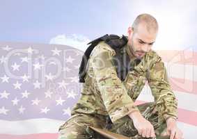 Soldier preparing his belongings against american flag background