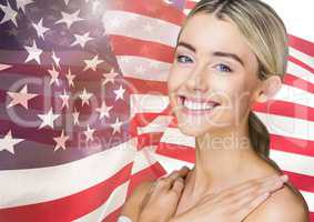 Smiling blond woman against american flag