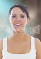 Woman in tank top against blurry blue brown background