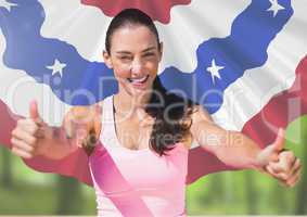 Sporty woman thumbs up against american flag