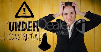Frustrated business woman against yellow wood panel and construction graphic