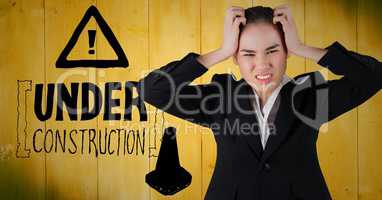 Frustrated business woman against yellow wood panel and construction graphic