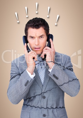 Frustrated business man with phones against cream background and 3d exclamation points