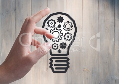 3d Hand pointing at cogs in lightbulb graphic and flare against grey wood panel