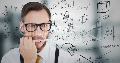 Frustrated business man with pen in mouth against 3D blurry grey office and math graphics