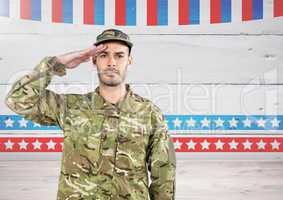 Soldier with hand on head in front of american background