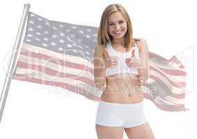 Pretty woman thumbs up against fluttering american flag