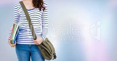 College student with books and bag against purple abstract background