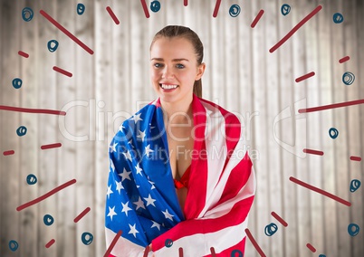 Woman wrapped in american flag behind red and blue firework doodles against blurry wood panel