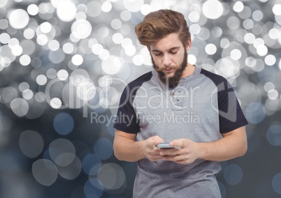 Man texting in colored lights background