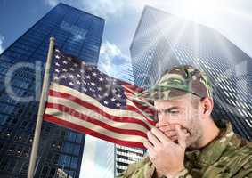 military covering his mouth against american flag and skyscrappers