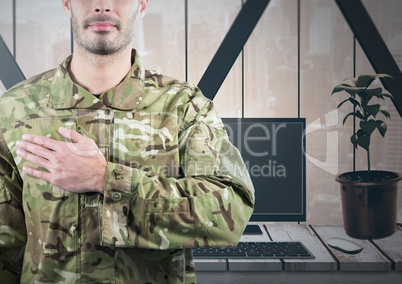 Soldier with hand on heart in front of his office