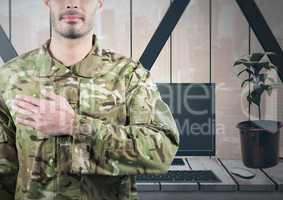 Soldier with hand on heart in front of his office
